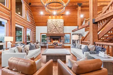 Log great room with stone fireplace at Unforgotten Utopia in Tollgate Canyon